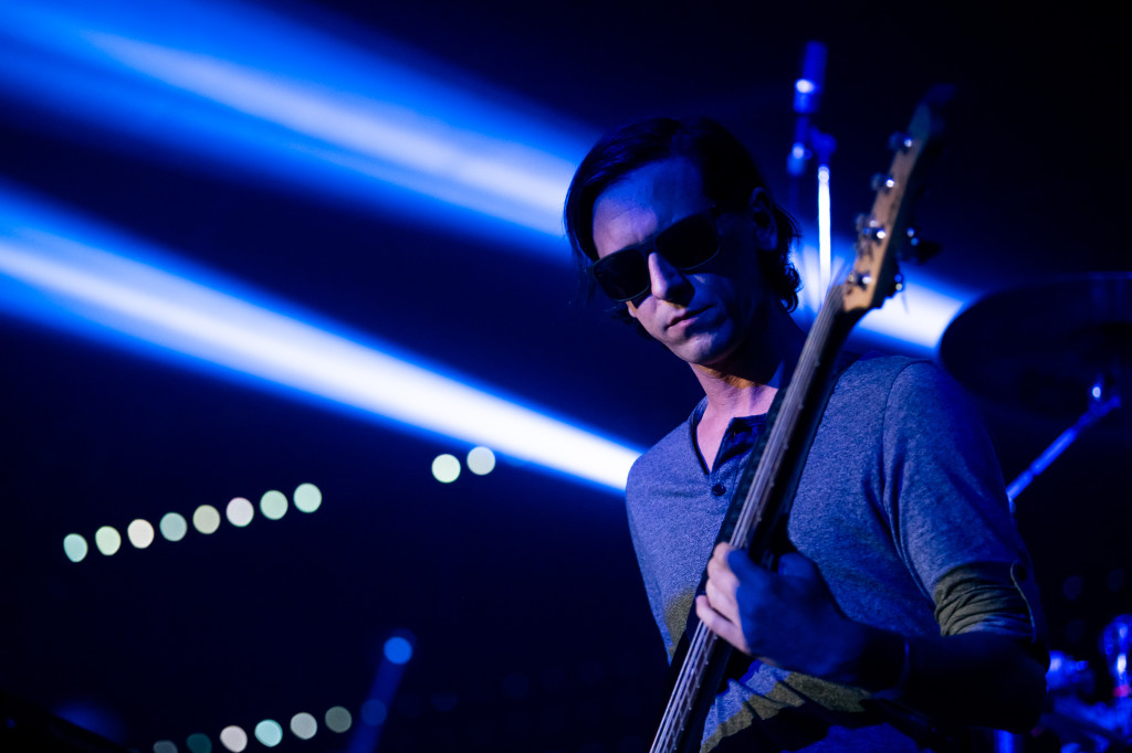 Akosch Warga playing bass beneath blue stage lights at Electronic Beats Festival, Budapest, 2018
