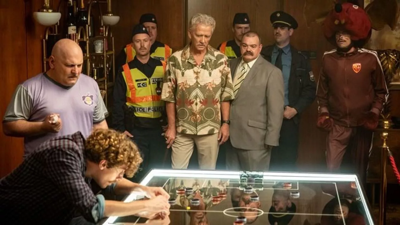 Film still from Lepattanó showing the characters gathered around a table football game